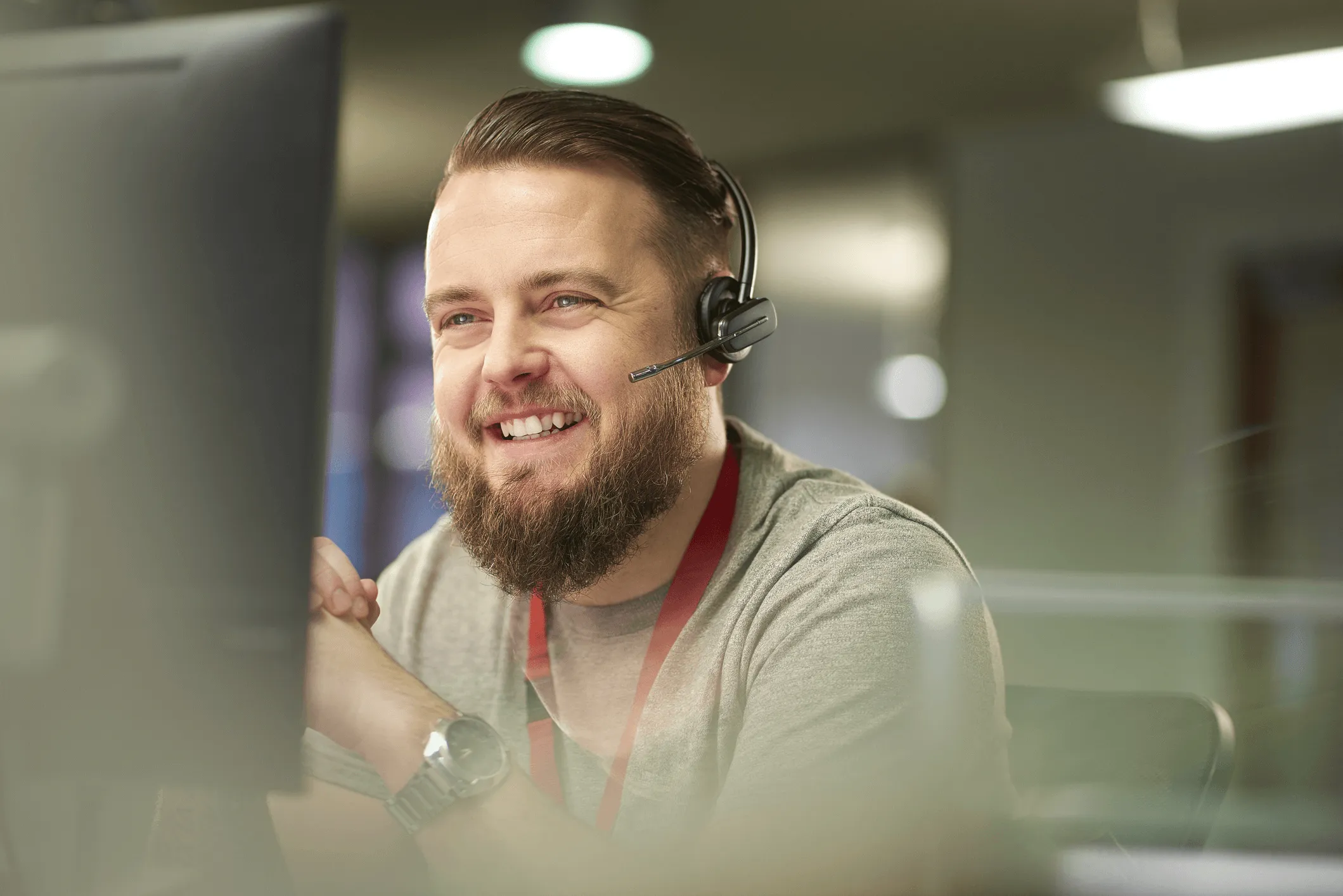 Remote IT consultant with headset on working on computer