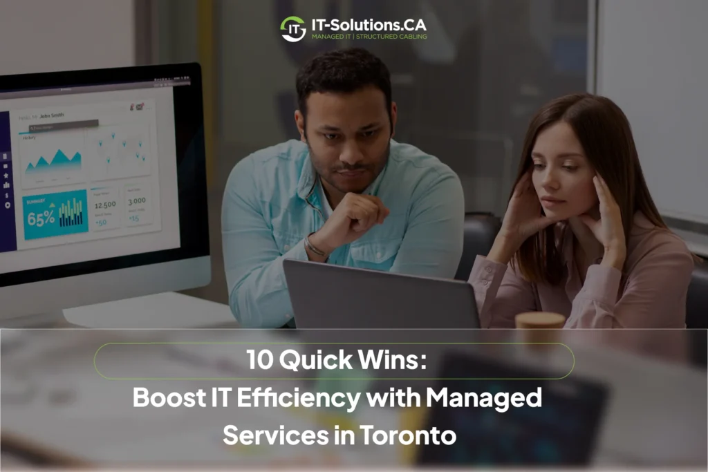 Man and woman analyzing business data on a laptop and monitor to improve IT efficiency with managed services in Toronto.