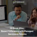 Man and woman analyzing business data on a laptop and monitor to improve IT efficiency with managed services in Toronto.